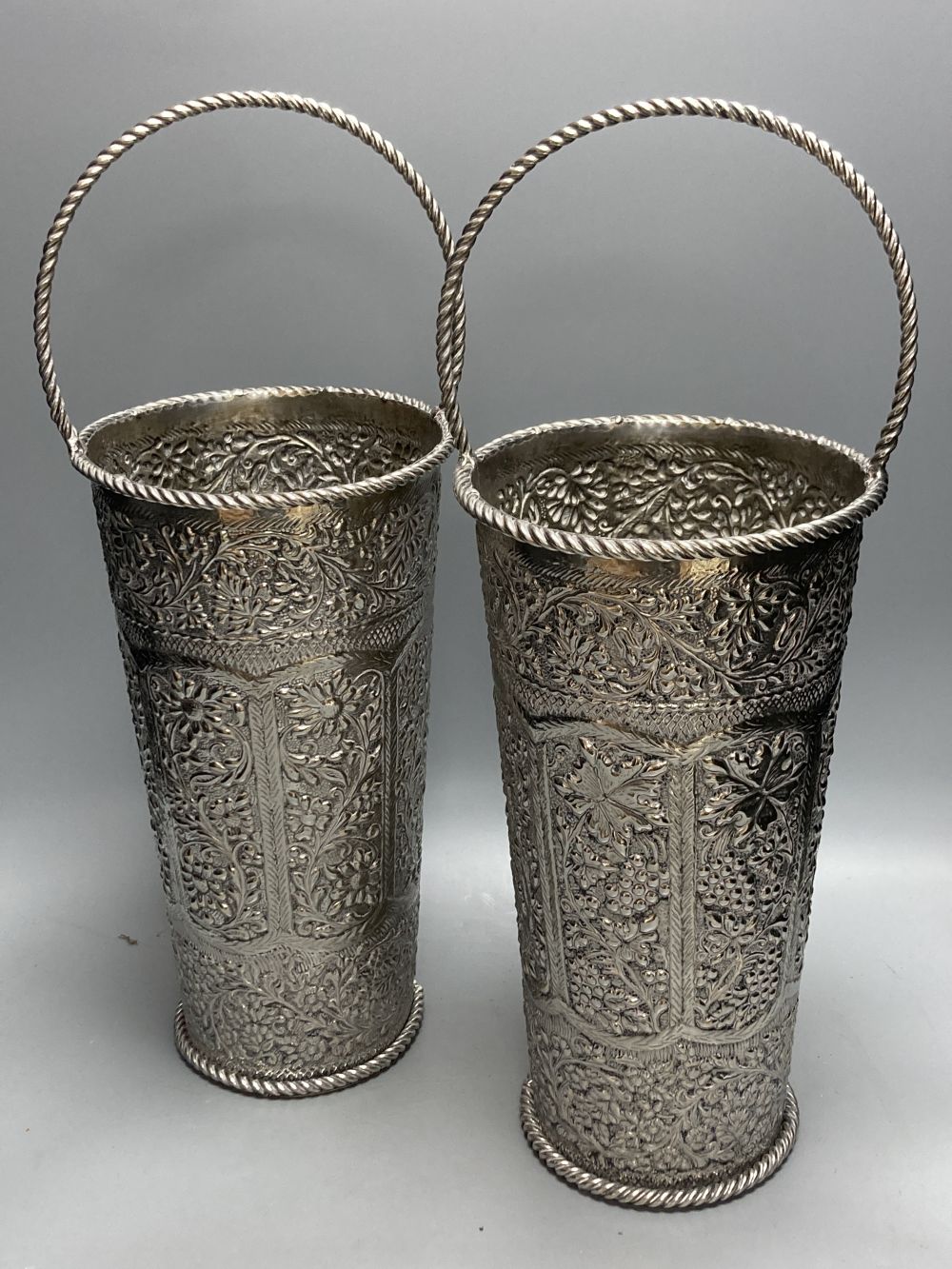 A pair of silver plated embossed champagne buckets, 48cm high including handle